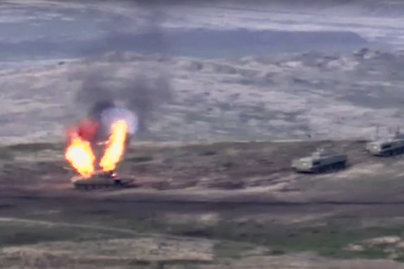 In this image taken from footage released by Armenian Defence Ministry, Armenian forces destroy an Azerbaijani tank at the contact line of the self-proclaimed Republic of Nagorno-Karabakh.