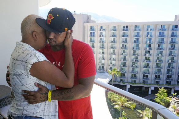 J.P. Mayoga (right), a chef at the Westin Maui Resort & Spa and his wife Makalea Ahhee hug on their balcony at the hotel near Lahaina, Hawaii. About 200 employees are living there with their families.
