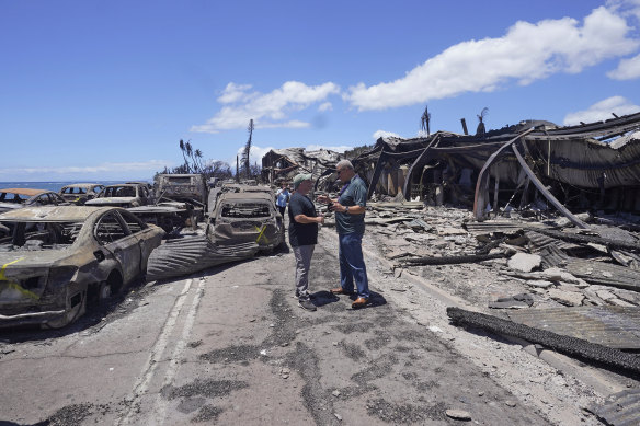 Governor of Hawaii Josh Green, left, and Maui County Mayor Richard Bissen, Jr., speak during a tour of wildfire damage.