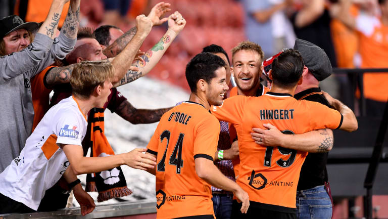 Adam Taggart celebrates one of his two goals with Roar fans.