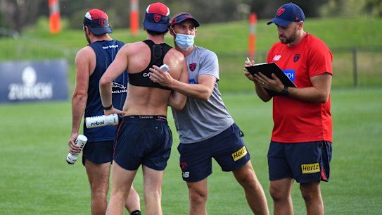 Simon Goodwin with players at Casey Fields on Wednesday morning.
