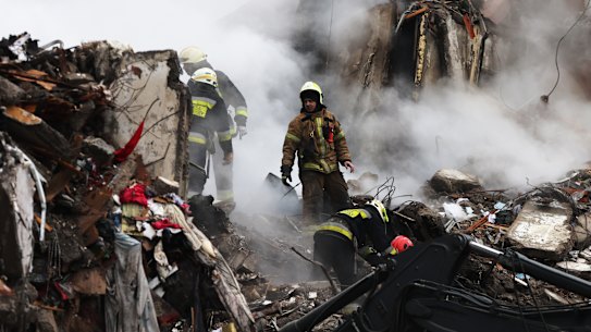 Emergency workers search the remains of a residential building that was struck by a Russian missile yesterday on January 15, 2023 in Dnipro, Ukraine. At least 20 people were reported dead after a missile hit the apartment building on Saturday, part of fresh wave of missiles launched by Russia. The Ukrainian president said his forces shot down 20 of 30 missiles fired by Russia on Saturday. (Photo by Spencer Platt/Getty Images)