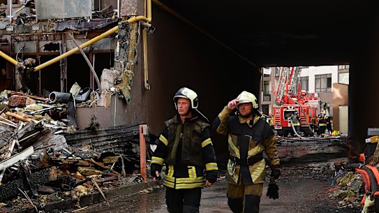 Firemen at the scene of a Kyiv apartment building hit by a missile attack on Sunday.