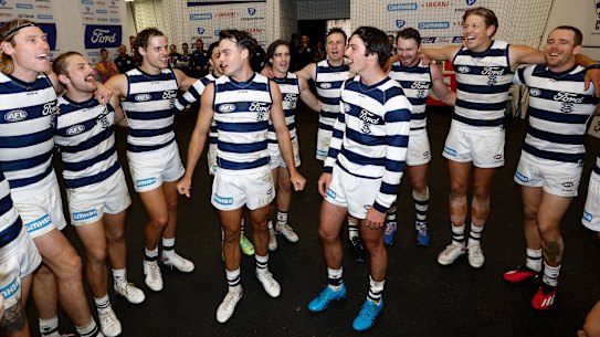 Jack Bowes and Oliver Henry sing the song for the first time as Geelong players after the Cats’ win over Hawthorn.