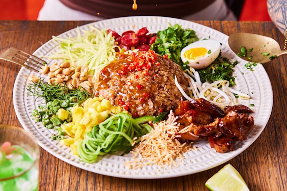 Toss the khao yum (Thai rice salad) to ensure maximum flavour in every bite.