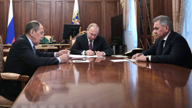 President Vladimir Putin at a meeting with Foreign Minister Sergey Lavrov (left) and Defence Minister Sergei Shoigu (right) in the Kremlin.