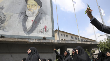 Under a portrait of the late Iranian revolutionary founder Ayatollah Khomeini, worshippers chant slogans in a pro-Palestinian rally in Tehran.