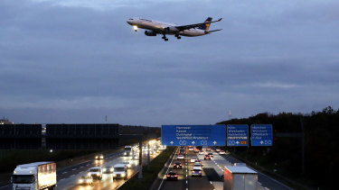 A Lufthansa aircraft approaches the runway at the airport in Frankfurt, Germany. The new law includes incentives for people to choose trains over planes.