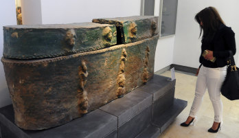 This photo released by the Syrian official news agency shows a visitor looking at ancient artefacts during the reopening ceremony for Syria's National Museum of Damascus.