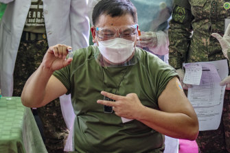 Philippine Army Commanding General Jose Faustino jnr poses with a vial of Sinovac Biotech’s CoronaVac, after being vaccinated last month.