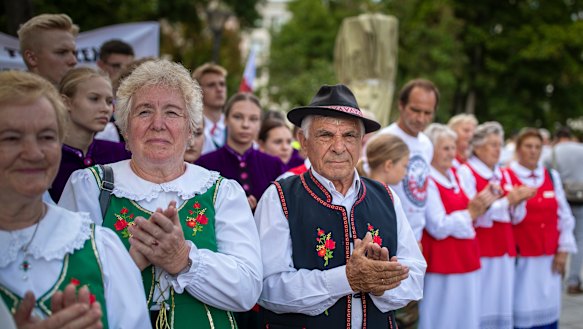 Protesters wearing traditional Lithuanian outfits attend an anti-migrant protest rally at the Vinco Kudirkos Square, in front of the government palace in Vilnius, Lithuania.