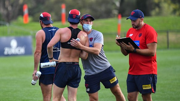 Simon Goodwin with players at Casey Fields on Wednesday morning.