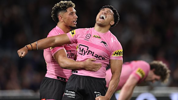 Paul Alamoti – wearing Penrith’s now-famous pink jersey – celebrates the Panthers’ grand final win.