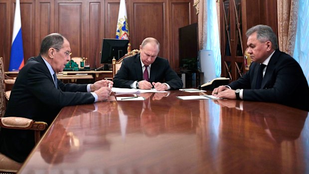 President Vladimir Putin at a meeting with Foreign Minister Sergey Lavrov (left) and Defence Minister Sergei Shoigu (right) in the Kremlin.