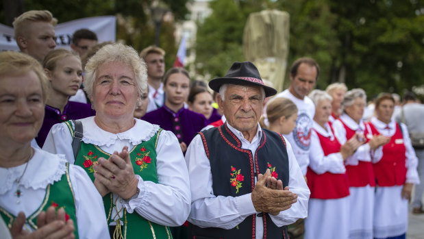 Protesters wearing traditional Lithuanian outfits attend an anti-migrant protest rally at the Vinco Kudirkos Square, in front of the government palace in Vilnius, Lithuania.