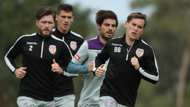 Neil Kilkenny leads Alex Grant, Bruno Fornaroli and Tomislav Mrcela while running during a Perth Glory A-League training session at UWA Sports Park.