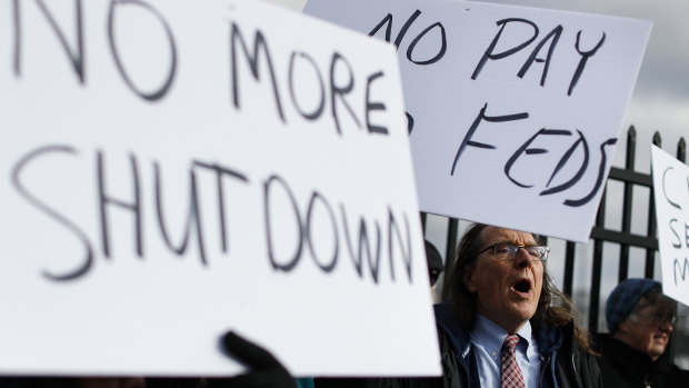 Union members and Internal Revenue Service workers rally outside an IRS Service Centre to call for an end to the partial government shutdown.