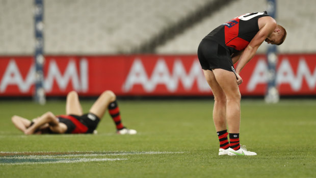 Dejected Essendon players after the final siren of the game against the Swans at the MCG.