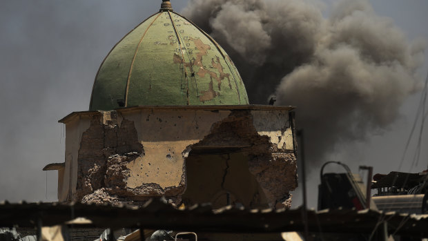 Smoke fills the air from an airstrike behind the historic Great Mosque of al-Nouri that was blown up by Islamic State militants as they retreated in Mosul in 2017. 