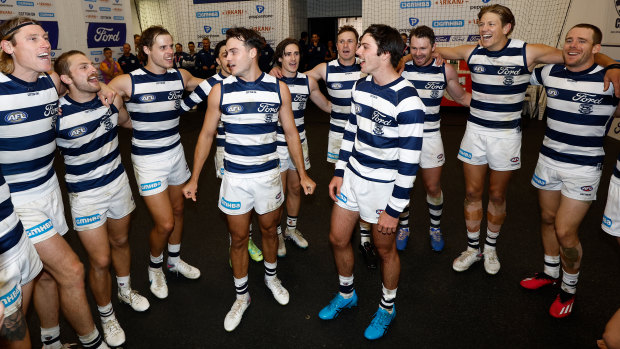 Jack Bowes and Oliver Henry sing the song for the first time as Geelong players after the Cats’ win over Hawthorn.