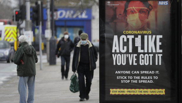 A sign at a bus stop in West Ealing in London reminds passersby to beware of spreading the virus. 