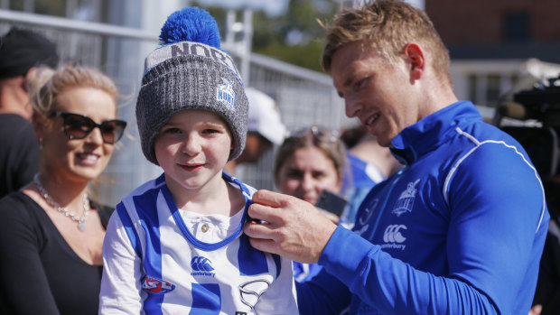 Meet and greet: Jake Ziebell takes time out from training at Arden Street Oval to connect with North Melbourne supporters young and old.