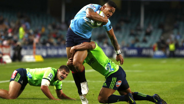 Dominant: Israel Folau charges through the Highlanders defence during a commanding win  for the Waratahs.