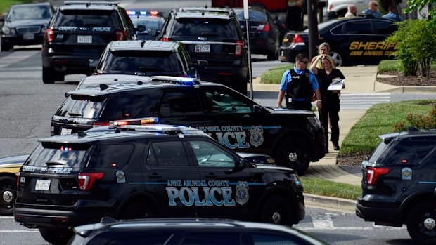 Police surround the Capital Gazette building after the shooting. 