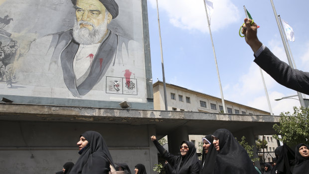 Under a portrait of the late Iranian revolutionary founder Ayatollah Khomeini, worshippers chant slogans in a pro-Palestinian rally in Tehran.