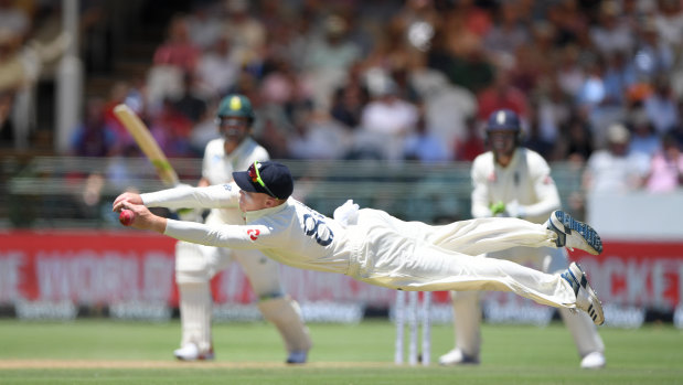 England fielder Ollie Pope dives in vain to cling onto a chance off Dean Elgar.