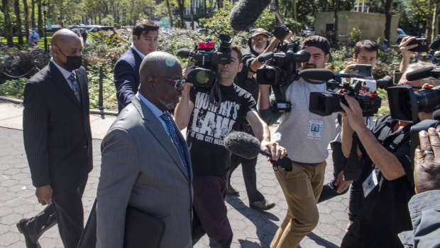 Deveraux Cannick, lawyer for R. Kelly, is surrounded by the media during a break at the Brooklyn Federal Court House in New York.