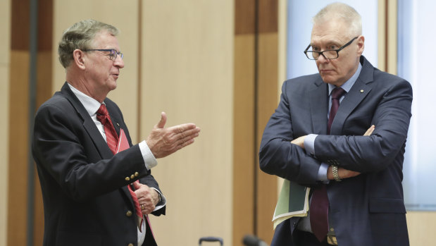 Professor Peter Collignon and Adjunct Professor Bill Bowtell at a Senate select committee hearing on the coronavirus in Canberra last month. 