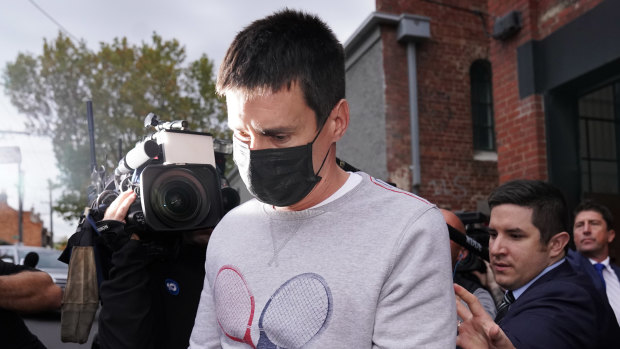 Richard Pusey is led from his home by police in Melbourne on Thursday afternoon.