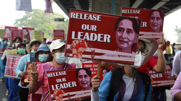 University teachers march with the images of deposed Myanmar leader Aung San Suu Kyi in Yangon, Myanmar, Friday, Feb. 26, 2021. 