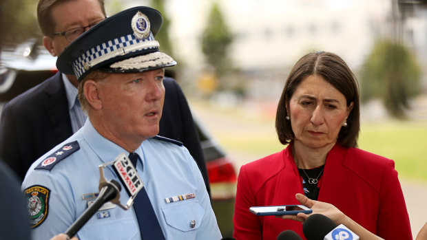  NSW Police Commissioner Mick Fuller addresses the media beside Premier Gladys Berejiklian and NSW Police Minister Troy Grant in Sydney on Sunday.