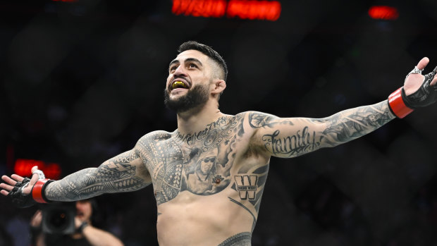 Tyson Pedro celebrates victory in the UFC octagon.