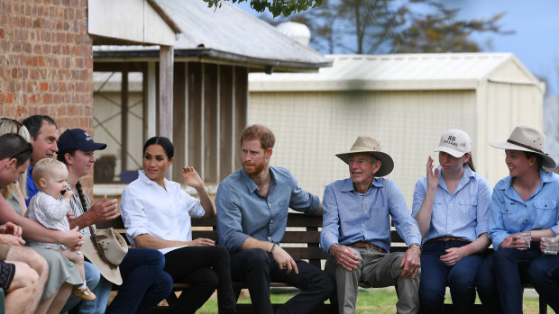 Britain's Prince Harry, the Duke of Sussex and his wife Meghan, the Duchess of Sussex enjoy a morning tea during a visit to the drought-affected farm of Mountain View near Dubbo.