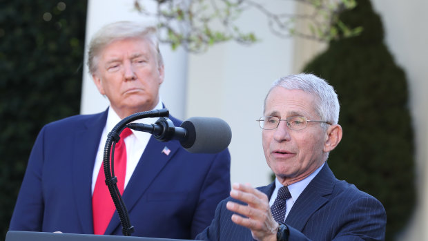 Dr Anthony Fauci, director of the National Institute of Allergy and Infectious Diseases, right, helped make the case for a longer shutdown to US President Donald Trump.