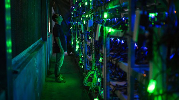A manager checks equipment in a bitcoin mine in Sichuan, China.