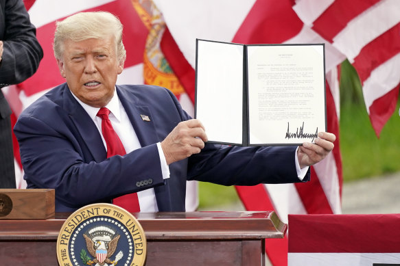 In Jupiter, Florida, President Donald Trump holds a signed memorandum to expand the offshore drilling moratorium to Florida's Atlantic coast, Georgia and South Carolina.
