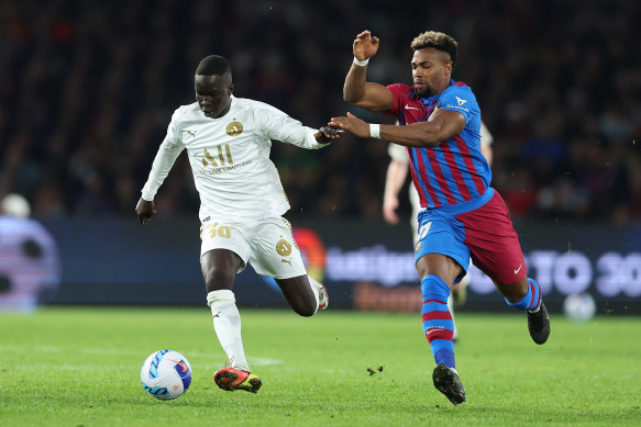 Garang Kuol holds off Barcelona's Adama Traore in May's friendly in Sydney.