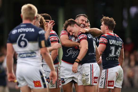 James Tedesco, playing his 200th NRL game, congratulates Sam Verrills on his try against the Cowboys.