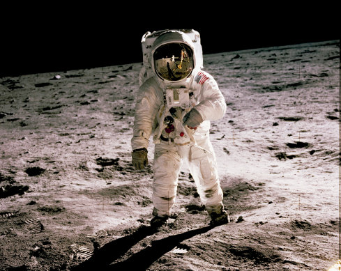 Buzz Aldrin walks on the moon in 1969. Fellow astronaut Neil Armstrong, the first to set foot on the moon, is seen reflected in Aldrin’s visor.