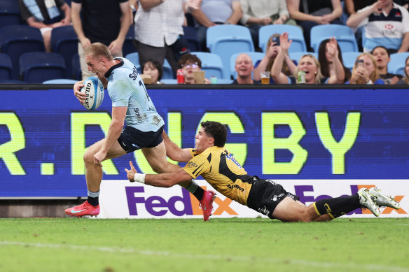 Max Jorgensen of the Waratahs scores a try against the Force.