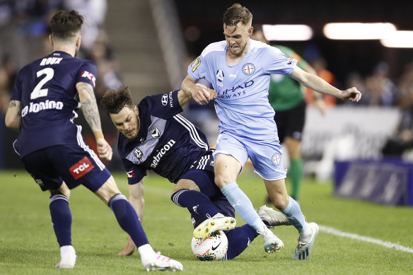 Melbourne City's Craig Noone, right, and James Donachie contest the ball. 