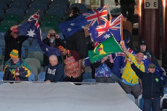 Australian flags fly in the stands on day two.