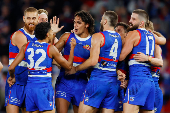 Jamarra Ugle-Hagan of the Bulldogs is swamped by teammates after one of his five goals.