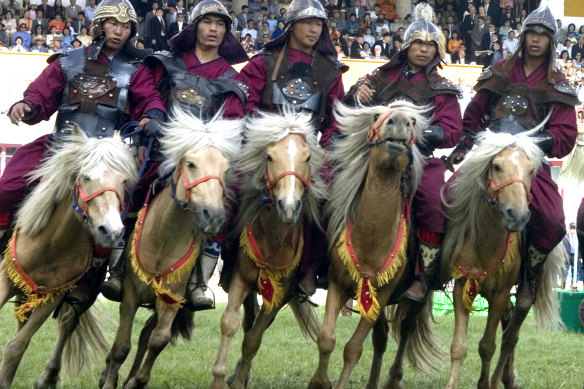 Riders in traditional dress perform at the opening ceremony of Naadam.