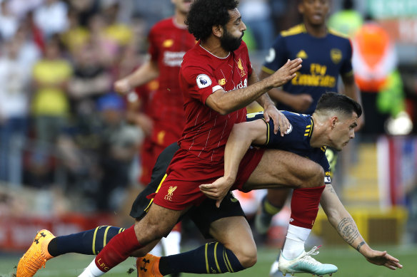 Liverpool's Mohamed Salah, left, challenges Arsenal's Granit Xhaka during Saturday's match. 