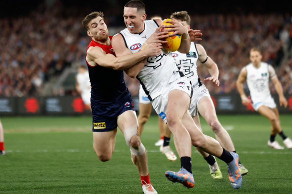 Jacob Weitering of the Blues is tackled by Jack Viney of the Demons during the 2023 AFL first semi final.